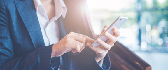 Business women hand are uses a smartphone in office.