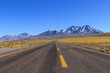 © Marcell - Long road with yellow lines going trough the beautiful view of mountains with snow at the Atacama Desert, Chile, South America