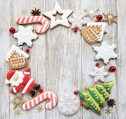 Wall Mural - Christmas homemade gingerbread cookies on a wooden background