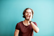 © rh2010 - Emotional portrait of a young caucasian bearded man with long hair dressed in t-shirt on the colorful background