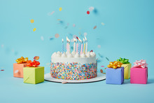 Tasty Cake With Candles, Colorful Gifts And Confetti On Blue Background