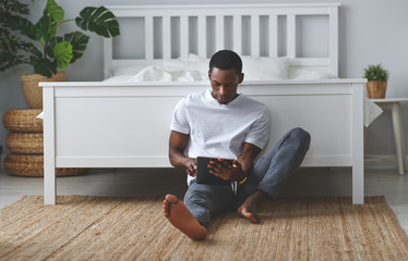 happy young african american black man with tablet in morning