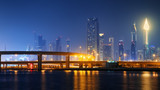 Fototapeta  - Beautiful view to Dubai downtown city center skyline reflected in water at night, United Arab Emirates