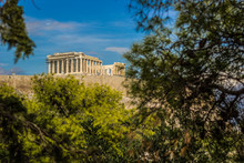 Acropolis Greece National Heritage Ruins Sightseeing Place In Reconstruction Time With Creative Foreshortening Between Tree Branches From Park Outdoor Point    