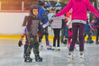 © Daniel CHETRONI - Adorable little boy in winter clothes with protections skating on ice rink