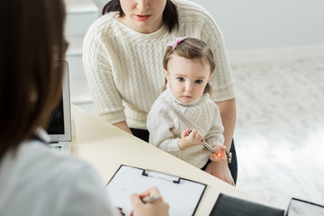 Pediatrician Meeting With Mother And Child In Hospital