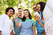 © Syda Productions - friendship, technology and international concept - group of friends with smartphone at summer park