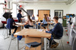 © Monkey Business - Class Of High School Students Sitting At Work Benches Listening To Teacher In Design And Technology Lesson