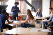 © Monkey Business - Class Of High School Students Sitting At Work Benches Listening To Teacher In Design And Technology Lesson