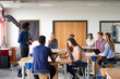 © Monkey Business - Class Of High School Students Sitting At Work Benches Listening To Teacher In Design And Technology Lesson