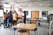 © Monkey Business - Group Of High School Students Standing Around Work Bench Listening To Teacher In Design And Technology Lesson