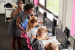 © Monkey Business - Teacher Helping Female Pupil Line Of High School Students Working at Screens In Computer Class