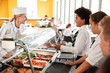 © Monkey Business - High School Students Wearing Uniform Being Served Food In Canteen