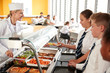 © Monkey Business - High School Students Wearing Uniform Being Served Food In Canteen
