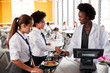 © Monkey Business - High School Students Wearing Uniform Paying For Meal In Cafeteria