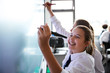 © Monkey Business - Female High School Students Wearing Uniform Using Interactive Whiteboard During Lesson