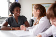 © Monkey Business - High School Tutor Giving Female Student Wearing Uniform One To One Tuition At Desk