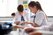 © Monkey Business - Two High School Students Wearing Uniform Working Together At Desk Using Digital Tablet