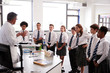 © Monkey Business - Male High School Tutor Teaching High School Students Wearing Uniforms In Science Class
