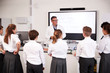 © Monkey Business - Male High School Tutor Teaching High School Students Wearing Uniforms In Science Class