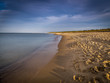 Long, empty and clean sand Stogi beach in the sunset near Gdansk, Poland with dramatic blue sky