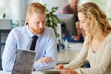 Two colleagues working in office together