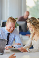 Two colleagues working in office together