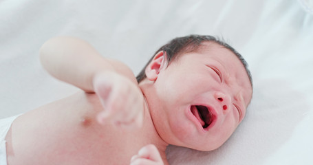 Wall Mural - New born baby crying on bed