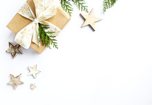 Christmas Present With Rustic Decorations And Evergreen Twigs. Flatlay. Copy Space. White Background