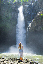 Girl On The Background Of A Waterfall
