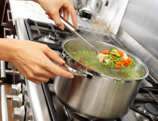 Canvas Print - WOMAN IN KITCHEN COOKING MIXED VEGETABLES