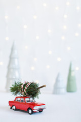 red toy car with a christmas tree on the roof