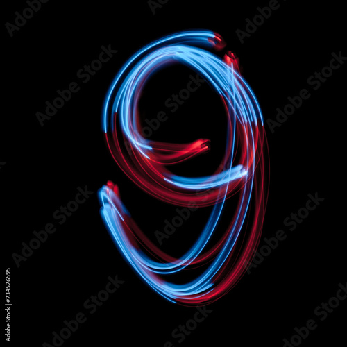Fotografía The neon number 9, blue light image, long exposure with colored fairy lights, ag