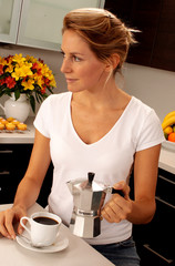 Wall Mural - WOMAN IN KITCHEN POURING COFFEE