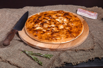 stuffed closed Calzone Pizza on a natural background