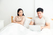 © Asada - An Asian man is working very happy in the bed room but his girlfriend is unhappy and unsatisfied about his manner because a man have not had a time for her. family,unhappy and divorce concept.