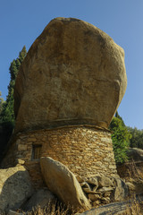 Sticker - ancient ikarian stone house with overhanging rock shelter on Ikaria Island, North Aegean Sea, Greece