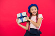 © be free - Best christmas gifts. Child excited about unpacking her gift. Kid little girl hold gift box with ribbon on red background. Christmas present for daughter. Small cute girl received holiday gift
