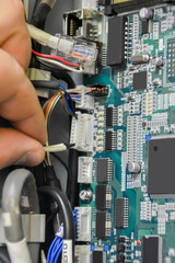 Repair electronic board. Removing socket from electronic board for check and repair. Industry concept.