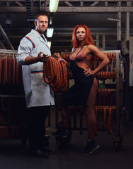 Butcher and his sexy girl assistant in the storage room.