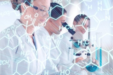 Wall Mural - Female and male scientists in glasses working with microscope