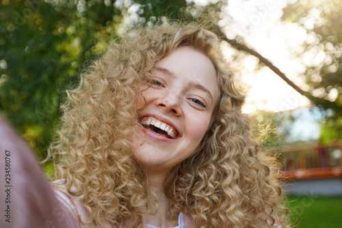 Young Beautiful Funny Cool Girl Blonde With Curly Hair Widely