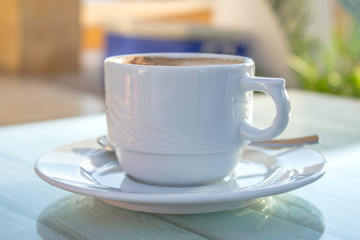 Wall Mural - coffee cup with latte art on wooden white table