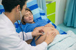 © Asada - Pregnant woman with doctor in hospital. Doctor using stethoscope examining pregnant girl. Mother,baby and family concept