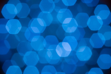 abstract beautiful blurred electric blue hexagon bokeh from ornamental lights flickering in the park