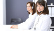 © rogerphoto - Call center. Group of operators at work. Focus on young brunette woman. Business  concept