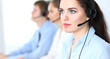 © rogerphoto - Call center operators at work. Focus at  business woman in headset