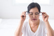 Elderly people woman suffering from eye pain hand holding eyeglasses