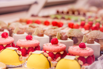 Various beautiful delicious pastries on a showcase in a French shop.