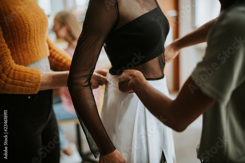 Fotografía Stylists doing a fitting for the model